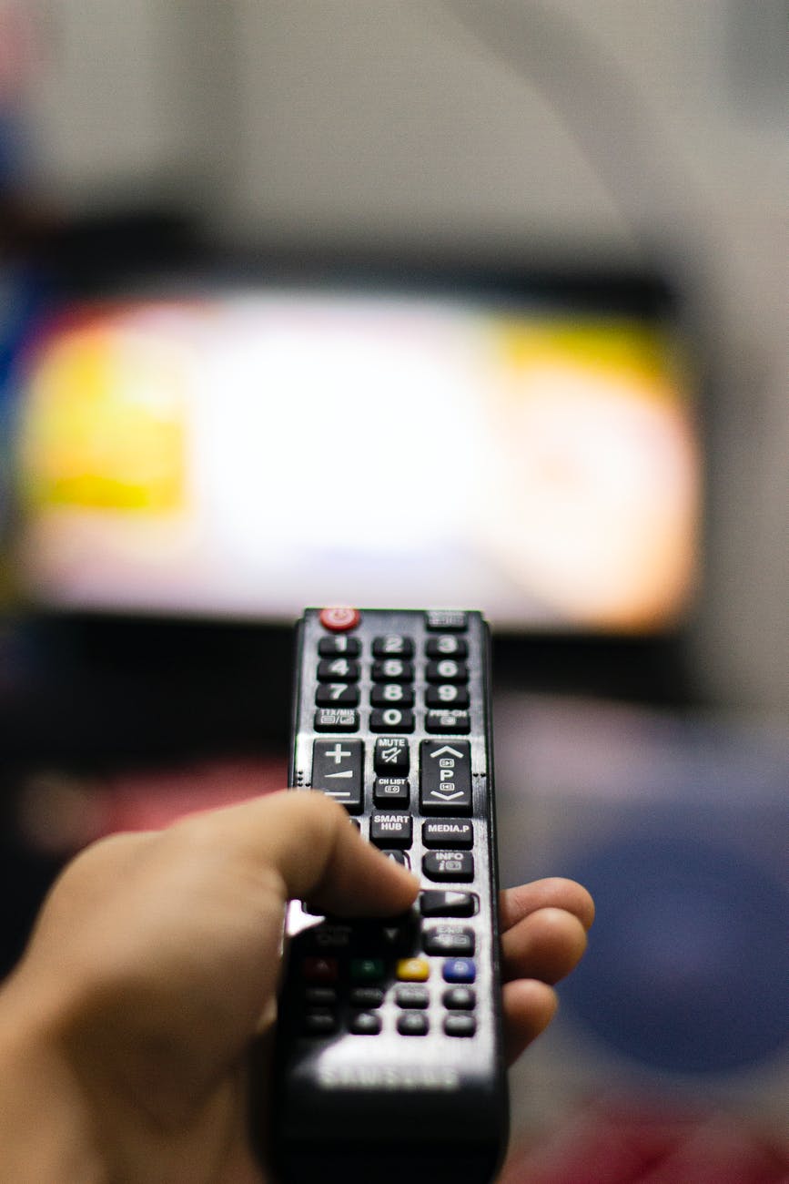 person holding black remote control